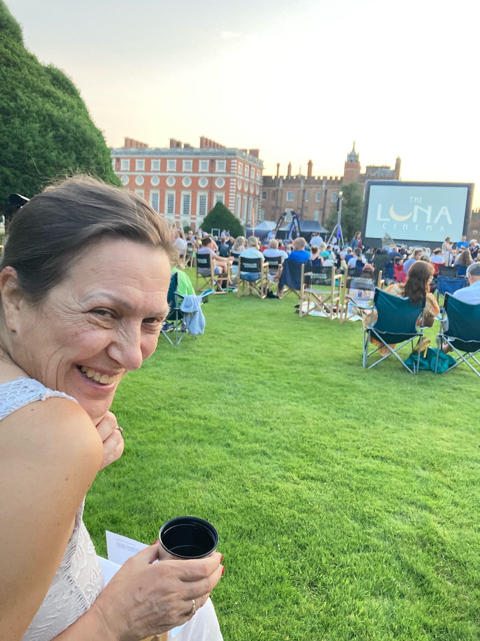Hampton court, open air cinema, Sara with a drink.